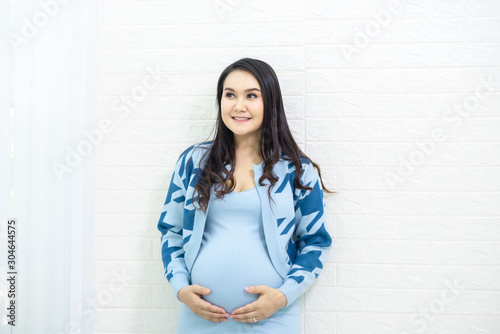 The woman is pregnant and she is happy to have a child.