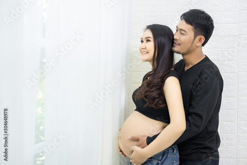 A beautiful pregnant woman and a handsome husband