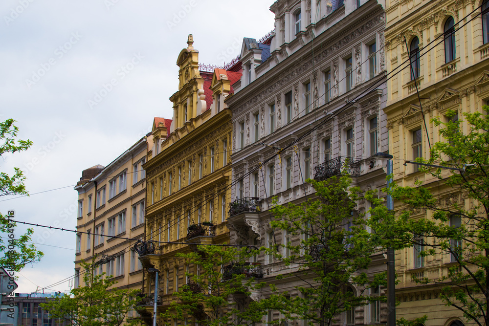 Facade of typical colorful classic buildings in a street in middle of Prague, Czech Republic