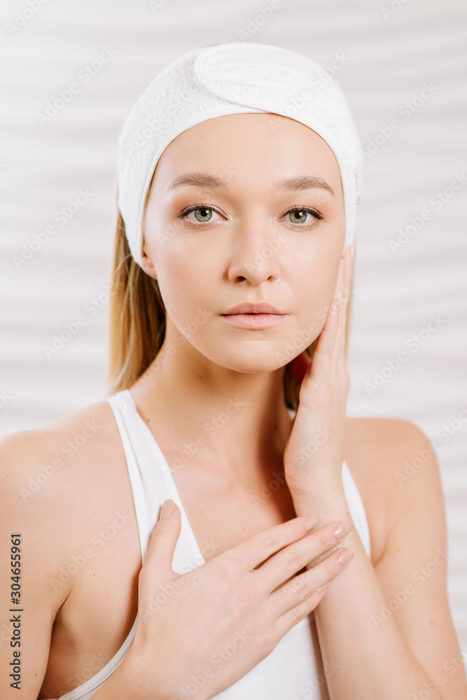 Close up beauty portrait of young woman in SPA center at the white background Close up beauty portrait of young woman in SPA center at the white background