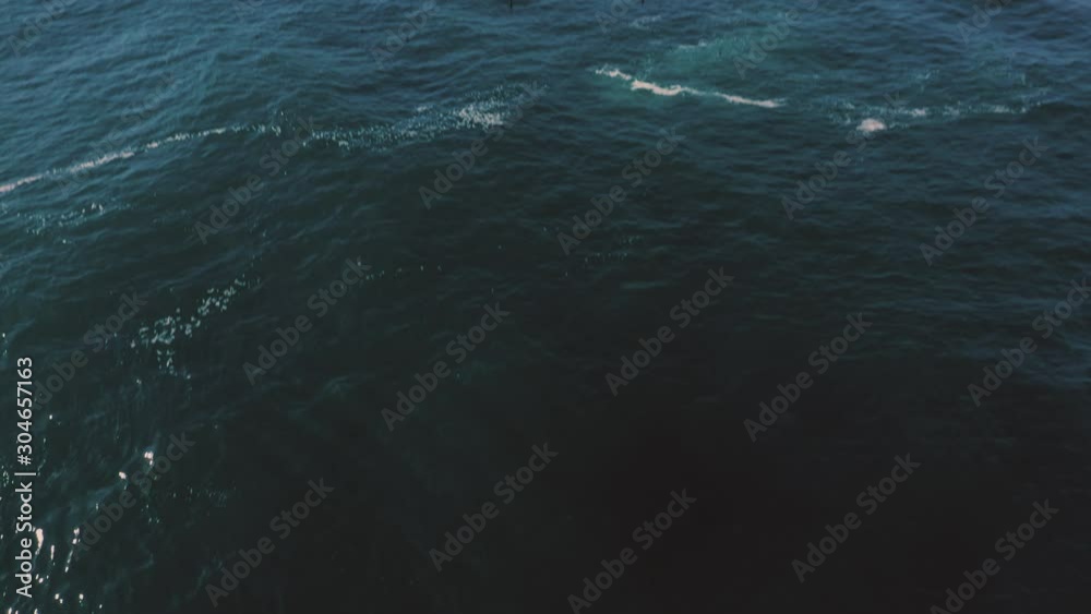 Tilt down aerial shot from horizon to ocean. Tilt down aerial shot from horizon to ocean.