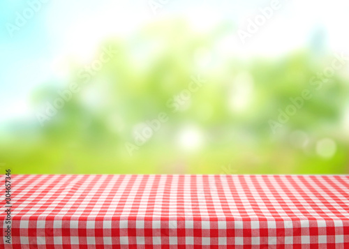 Canvastavla Checkered picnic red table cloth table on natural background.