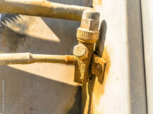 an old and rusty leaking pipe of central air conditioning unite fixed into AC heavy duty compressor