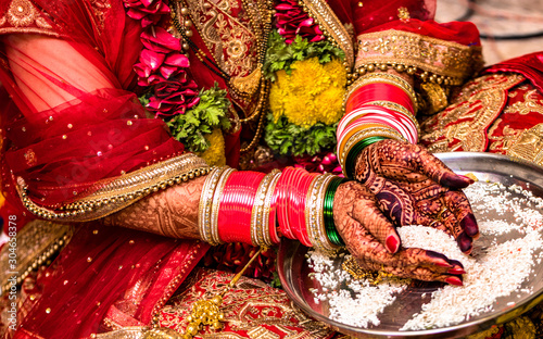 Fotografie Indian Hindu Bride wearing beautiful Red Lehenga in her marriage, and performing