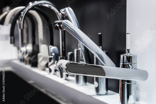 water faucets are on display in the store. The contrast of black and white
