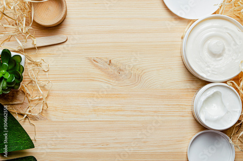 Natural cosmetics for face and body skin care.organic beauty.Natural cosmetics for face and body skin care. top view, light wooden background.