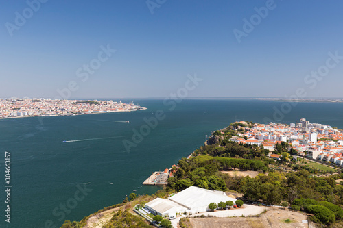 Fototapeta Naklejka Na Ścianę i Meble -  Lisbon and Almada cities and Tagus River in between in Portugal viewed from above on a sunny day in the summer.