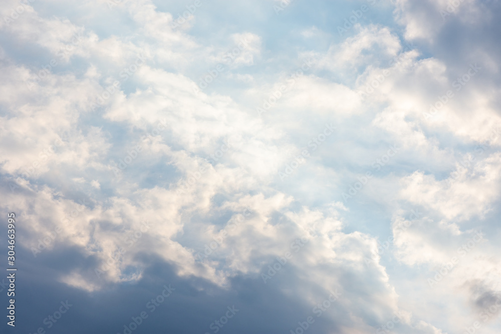 landscape sky with blue clouds and sunbeams at sunset. Background texture