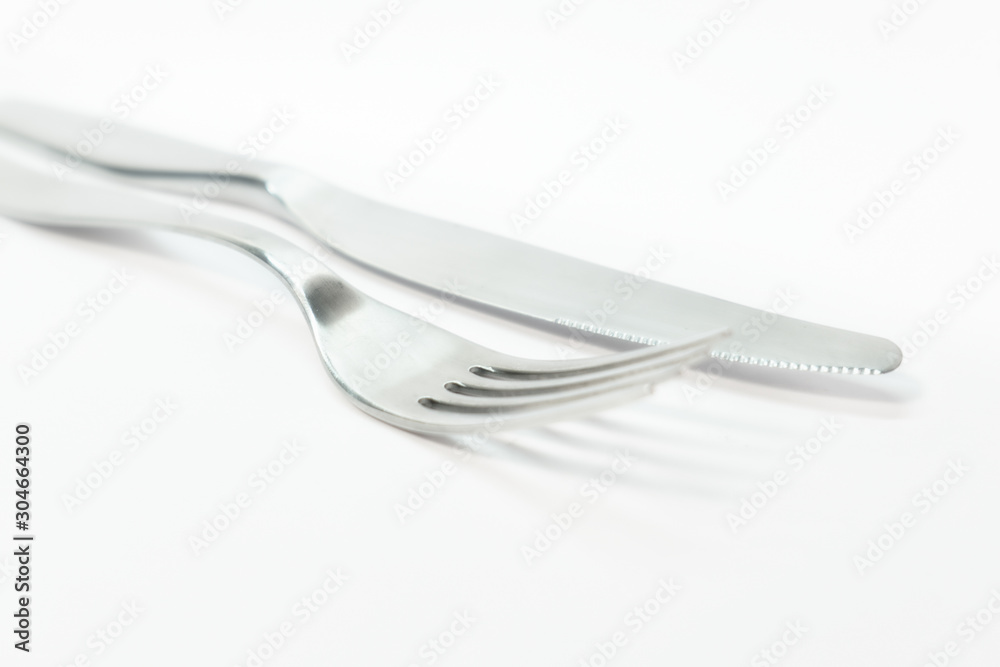 Shiny metal fork and knife on white background. Shiny metal fork and knife on white background.