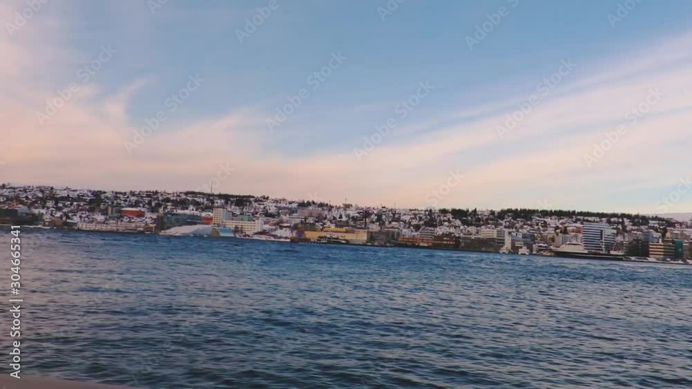 Northern city with natural lake in Norway shot from a moving car going up hill. Northern city with natural lake in Norway shot from a moving car going up hill.