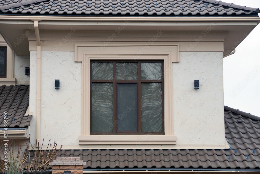  brown window on the gray wall of the attic house