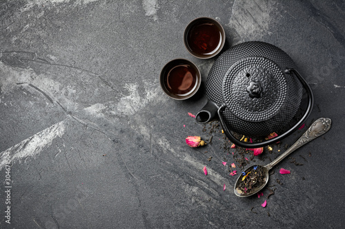 Black japanese cast iron teapot and flower tea with rose buds