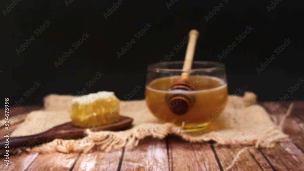 Honey is nutritious for health, stirring with a honey spoon and honeycomb Honey is nutritious for health, stirring with a honey spoon and honeycomb