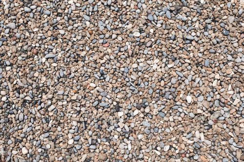 Wet round pebble. Beach ground texture
