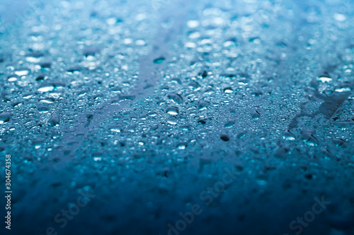 Wet windshield, blue glass surface