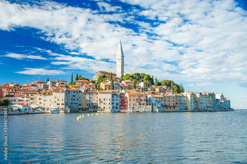 Beautiful town of Rovinj on seaside in Istria, Croatia. Old historic houses and cathedral tower bell on the peninsula on Adriatic sea coastline.