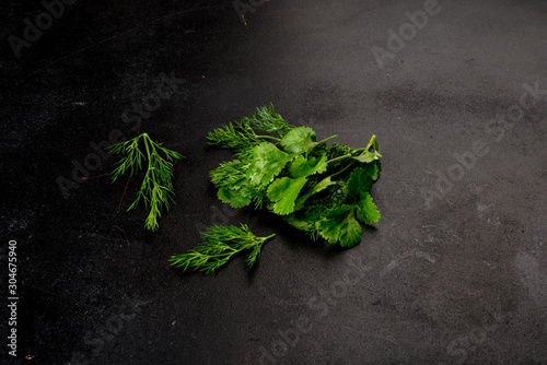 Fresh and dill, green parsley shot on a black background © sapunovaphoto