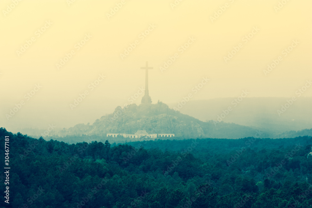 The giant cross. Escorial Monastery is the palace and residence of King Philip II of Spain.  Located near Madrid at the foot of the Sierra de Guadarrama mountains.