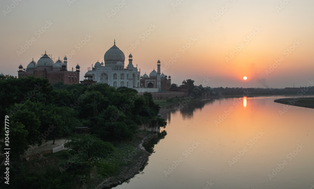Taj Mahal from the riverbank during a sunset