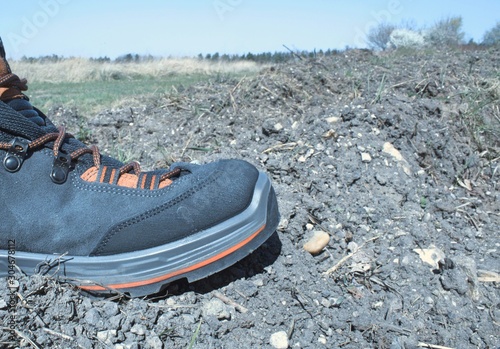 Hiking boot with landscape background