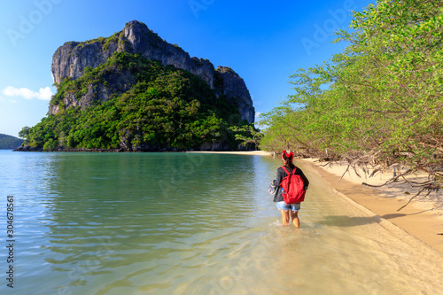 Woman walking on tropical beach