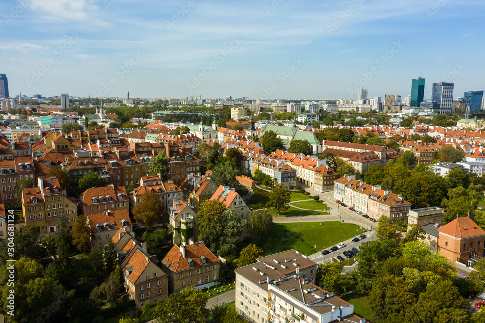 Aerial view of old buildings, castles and a church in the old city of Warsaw. Poland. Flight of the drone over the old city on a sunny summer day.