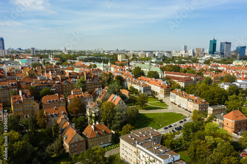 Aerial view of old buildings, castles and a church in the old city of Warsaw. Poland. Flight of the drone over the old city on a sunny summer day.