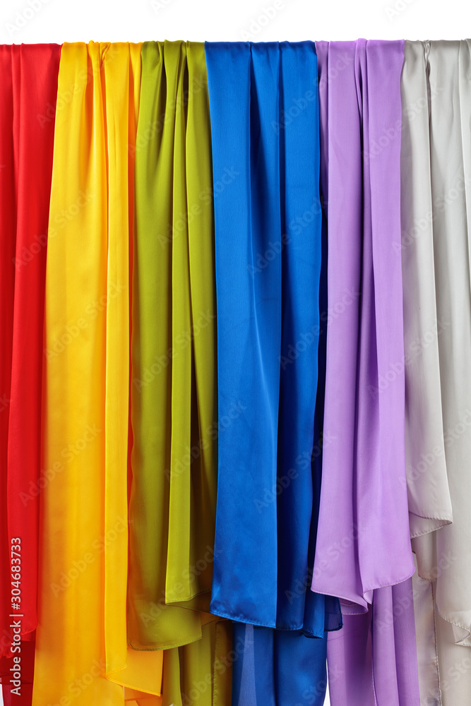 Vertical colorful satin curtains isolated on white.