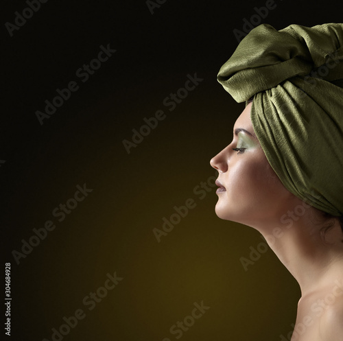 Portrait of a young attractive woman in a fancy headdress.