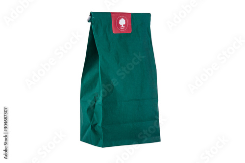 Paper package, green bag with herbs for tea isolated on a white background