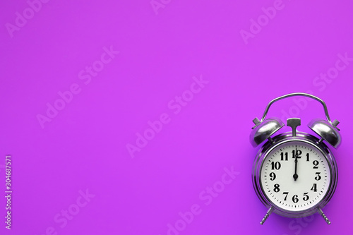 alarm clock on a purple background