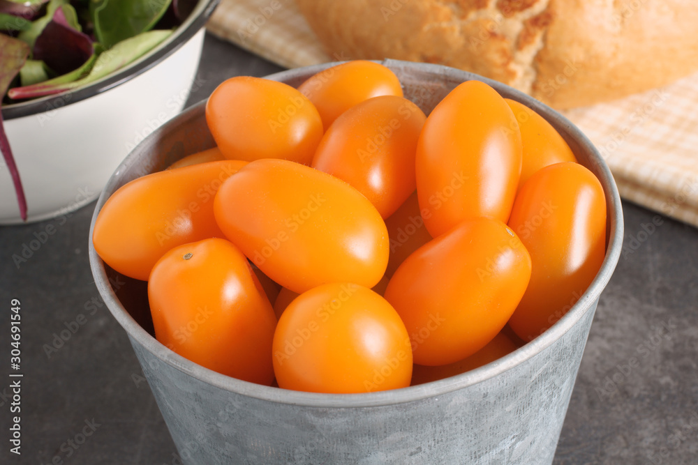 Orange Santa F1 grape tomatoes a hybrid variation of the more usual red tomato.
