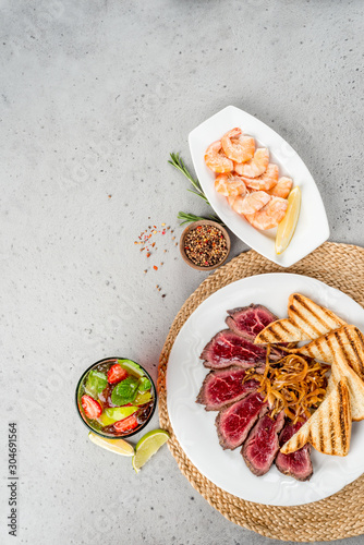 Roast beef and shrimp on a background shot by a suvur for a restaurant