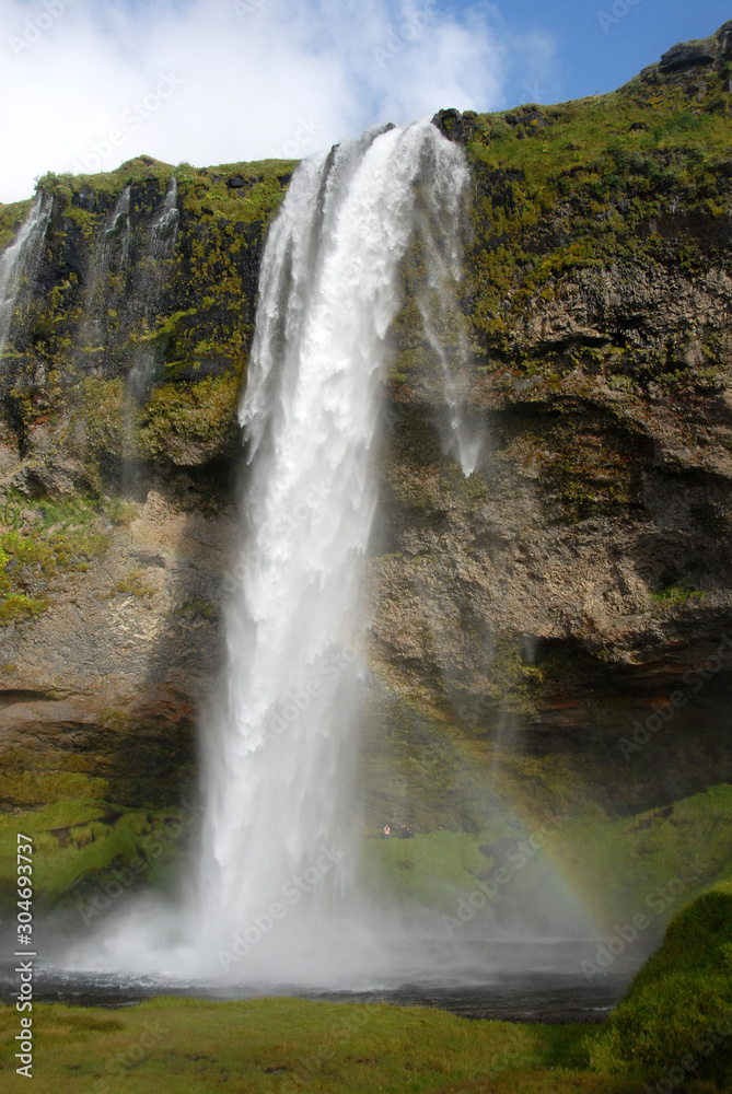 Seljalandsfoss Waterfall in Iceland. A famous waterfall with a path to walk behind the falls.