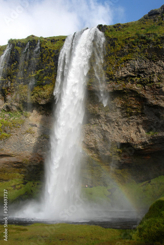 Seljalandsfoss Waterfall in Iceland. A famous waterfall with a path to walk behind the falls. © Jonathan Wilson