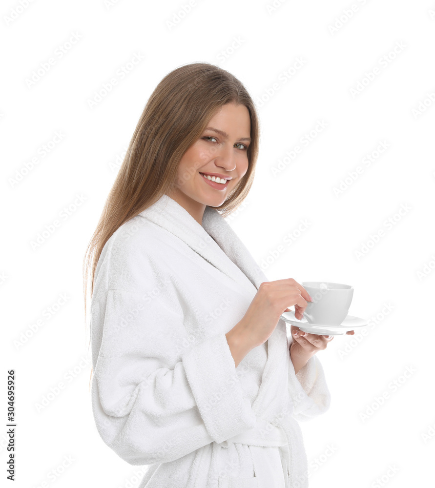 Young woman in bathrobe with cup of beverage on white background Young woman in bathrobe with cup of beverage on white background