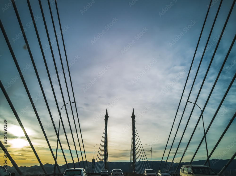 Obraz premium Towers of Bridge connecting George Town on Penang island and Seberang Prai on mainland of Malaysia through straits of Malacca.