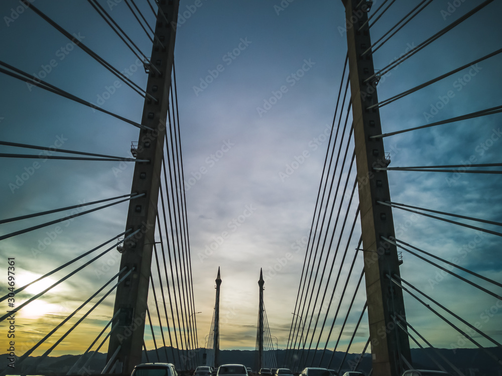 Fototapeta premium Towers of Bridge connecting George Town on Penang island and Seberang Prai on mainland of Malaysia through straits of Malacca.