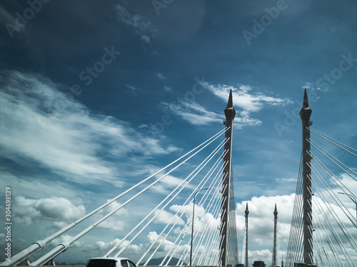 Towers of Bridge connecting George Town on Penang island and Seberang Prai on mainland of Malaysia through straits of Malacca. photo