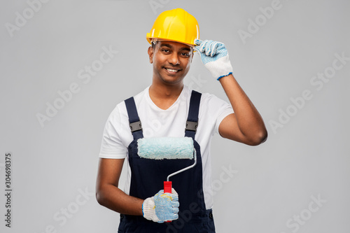 Fototapeta Naklejka Na Ścianę i Meble -  repair, construction and building - happy smiling indian builder or painter in helmet with paint roller over grey background