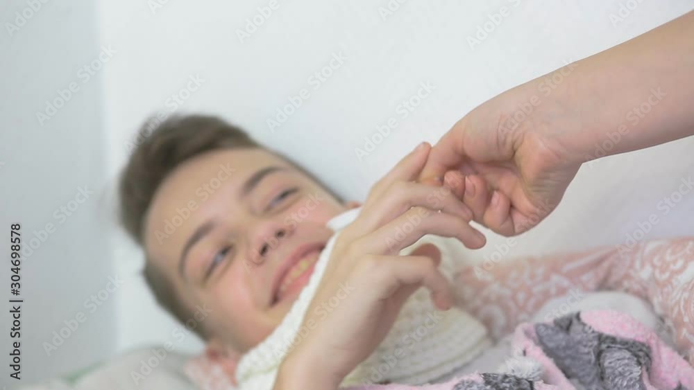 gay teen boy with a cold is lying in bed and afraid to take ...