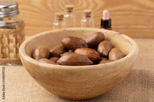 wooden bowl with pecan nuts in a rustic environment. Concept of the benefits of pecan oil on health