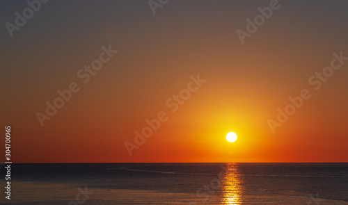 Dawn over the sea, a wonderful sun rises over the horizon. © Alexander