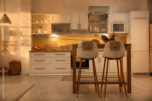 Modern kitchen interior with stylish wooden table © New Africa