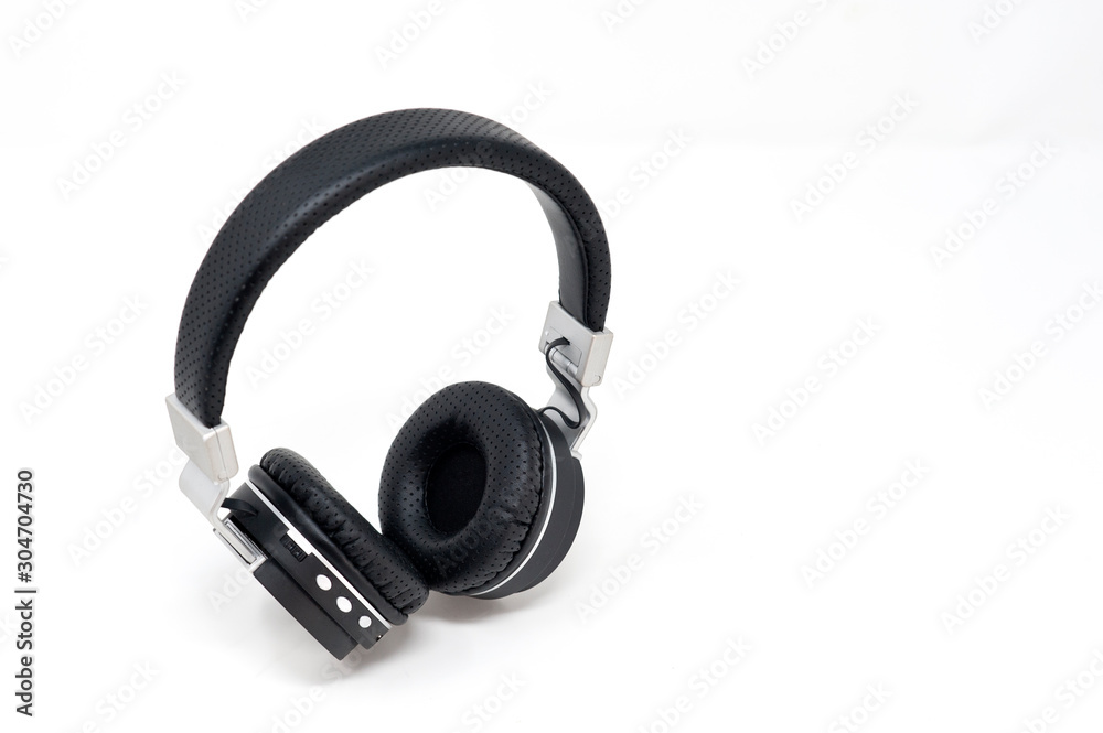 black and gray headphones placed in standing on white background black and gray headphones placed in standing on white background