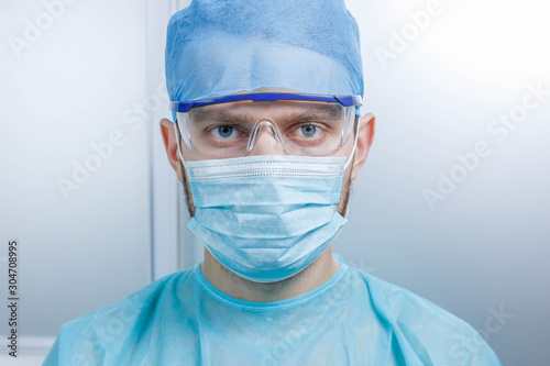 Portrait of a surgeon doctor in uniform at the medical office.