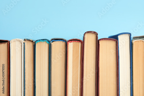 Collection of old books on light blue background