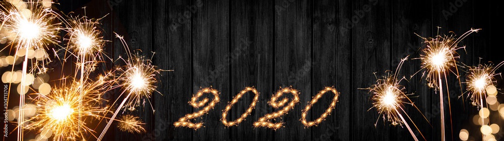 Silvester background banner panorama long- sparklers and bokeh lights on rustic wooden texture, top view with space for text - obrazy, fototapety, plakaty 