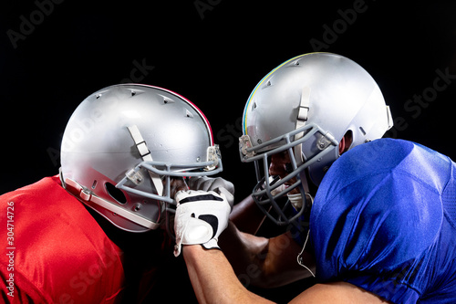 Two American football players in action