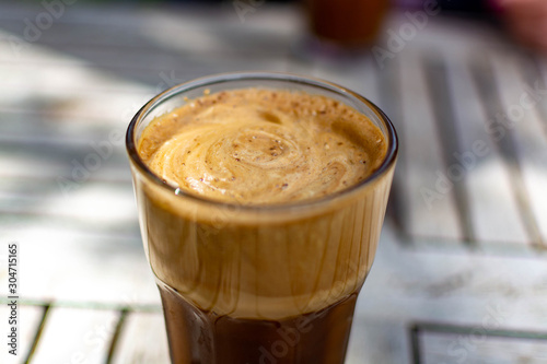 Traditional greek cold coffee Frappe made from water, instant coffee and ice cubes